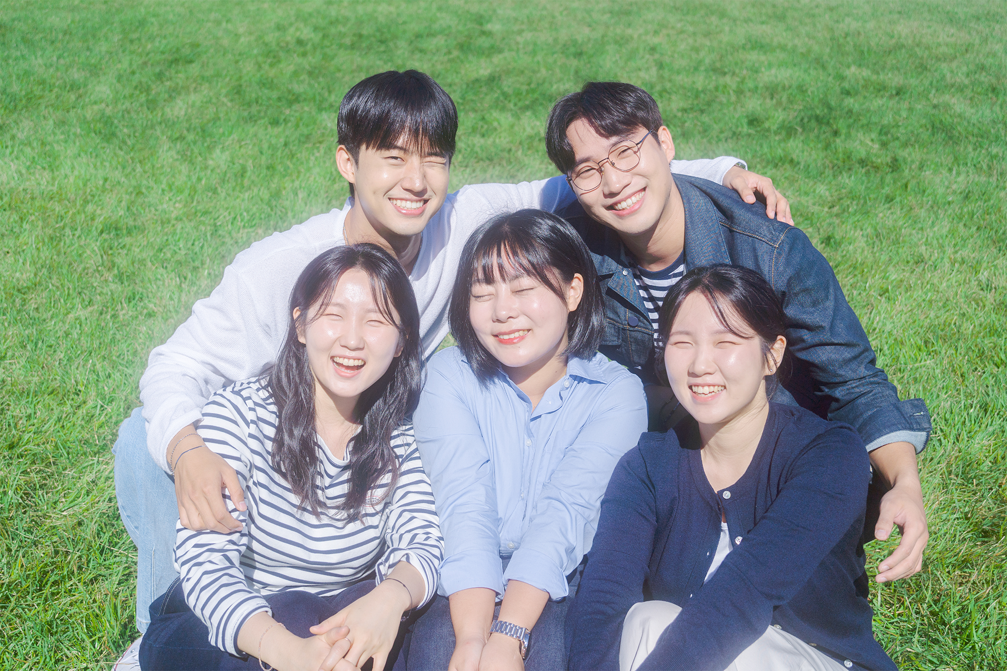 잔디밭에 함께 앉아 있는 WAYHOME 멤버 5명